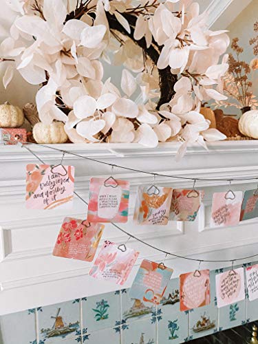 Affirmation Cards for Women – Inspirational Display for Home or Event Decor Affirmation Cards for Women displayed on a string with metal hangers, featuring floral designs and inspirational quotes above a decorated mantel