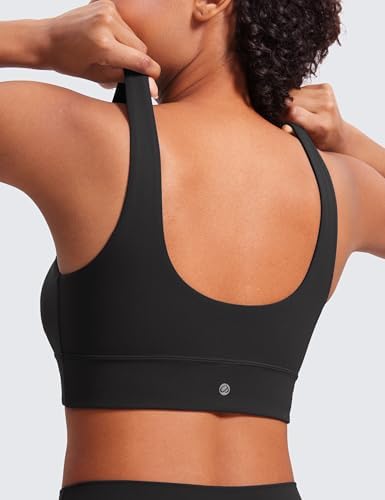 Butterluxe Sports Bra – Racerback Fit & Logo Detail Back view of Butterluxe Sports Bra in black, featuring racerback design and logo detail, with model adjusting shoulder straps