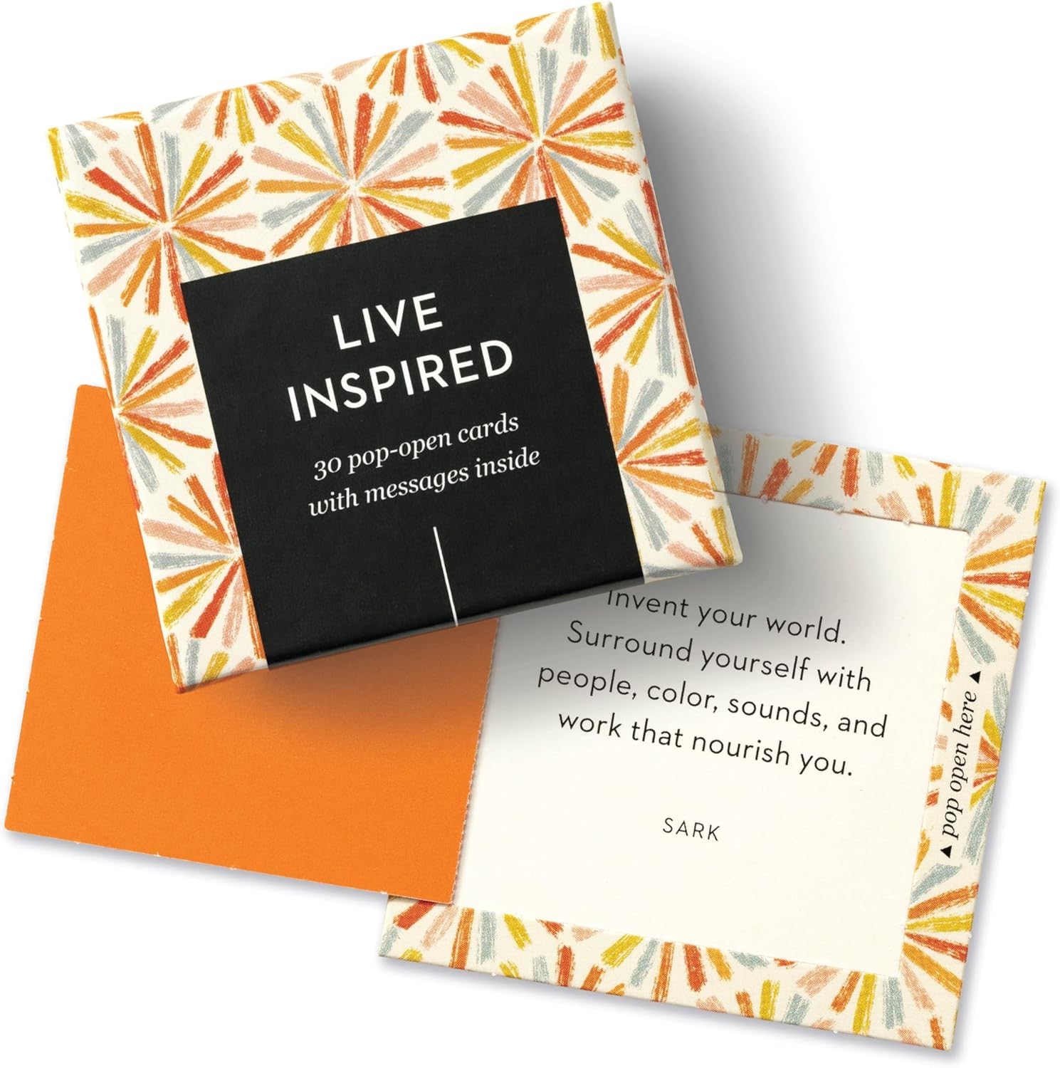 Affirmation Cards for Women – “Live Inspired” Pop-Open Box with Uplifting Messages Box of Affirmation Cards for Women with colorful starburst design, partially opened to reveal a motivational quote card inside