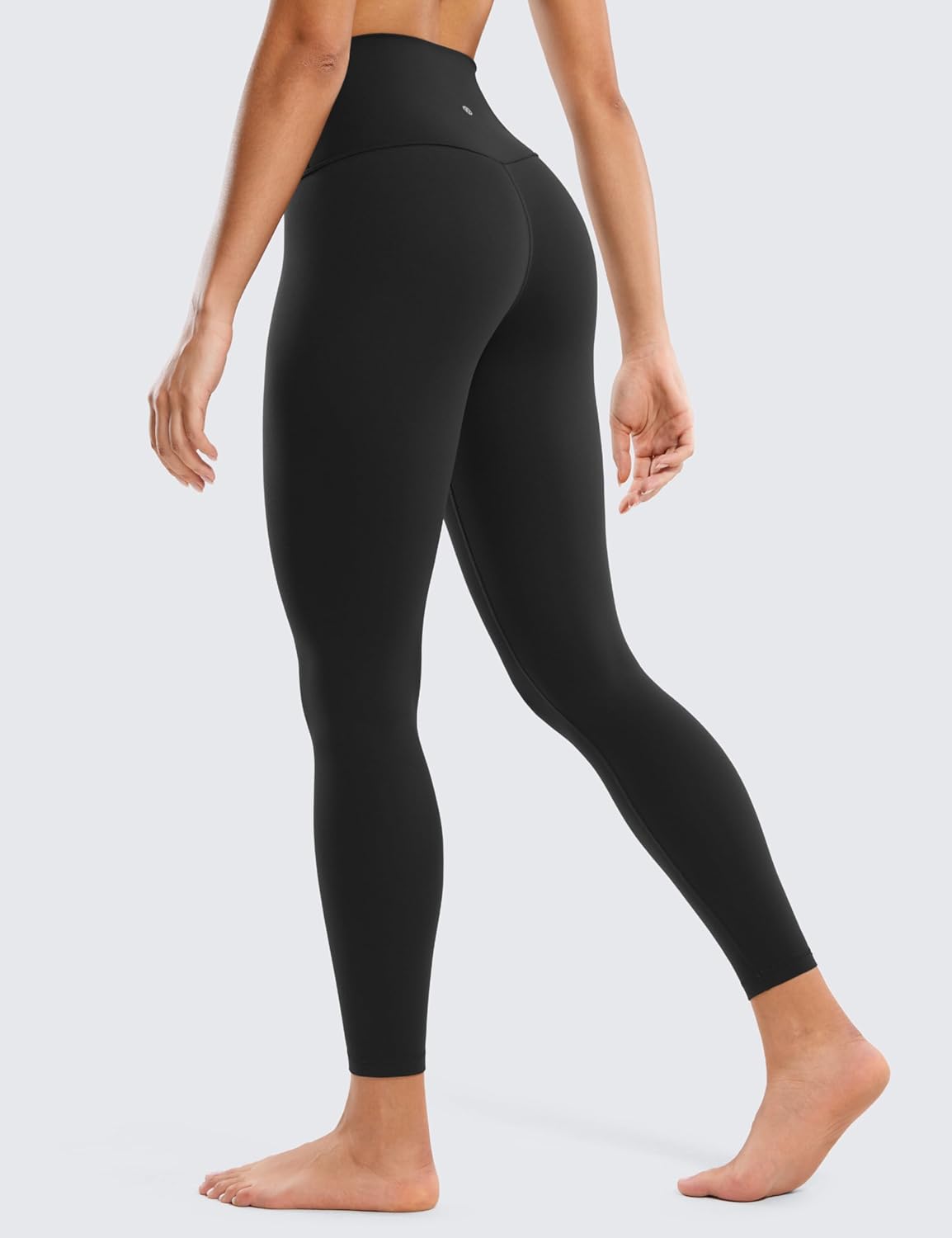 Butterluxe High-Waisted Leggings – Sleek Fit & All-Day Comfort Side and back view of Butterluxe High-Waisted Leggings in black, worn by barefoot model on light gray background