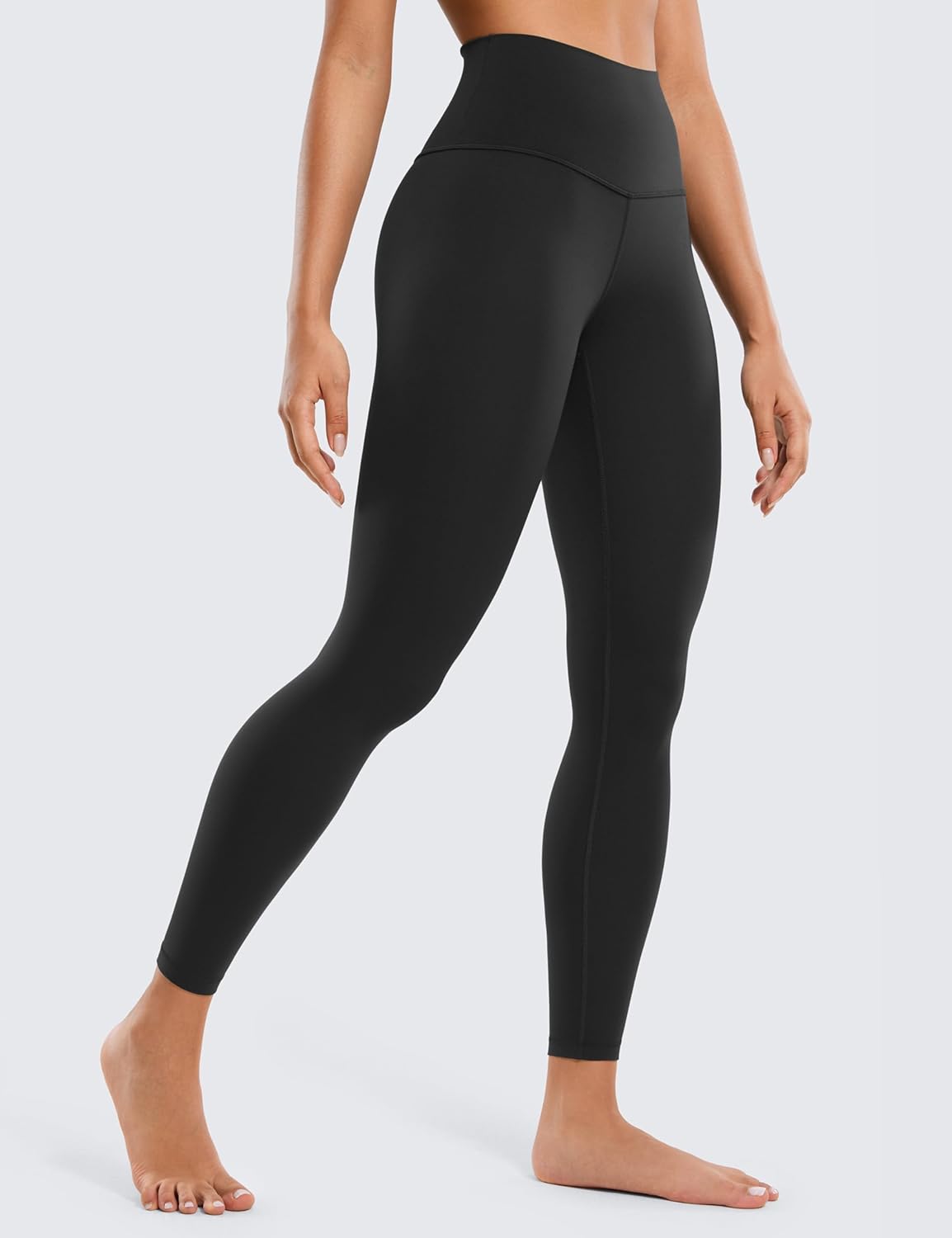 Butterluxe High-Waisted Leggings – Sleek Fit & Everyday Comfort Model wearing Butterluxe High-Waisted Leggings in black, standing barefoot to highlight sleek fit and ankle-length design