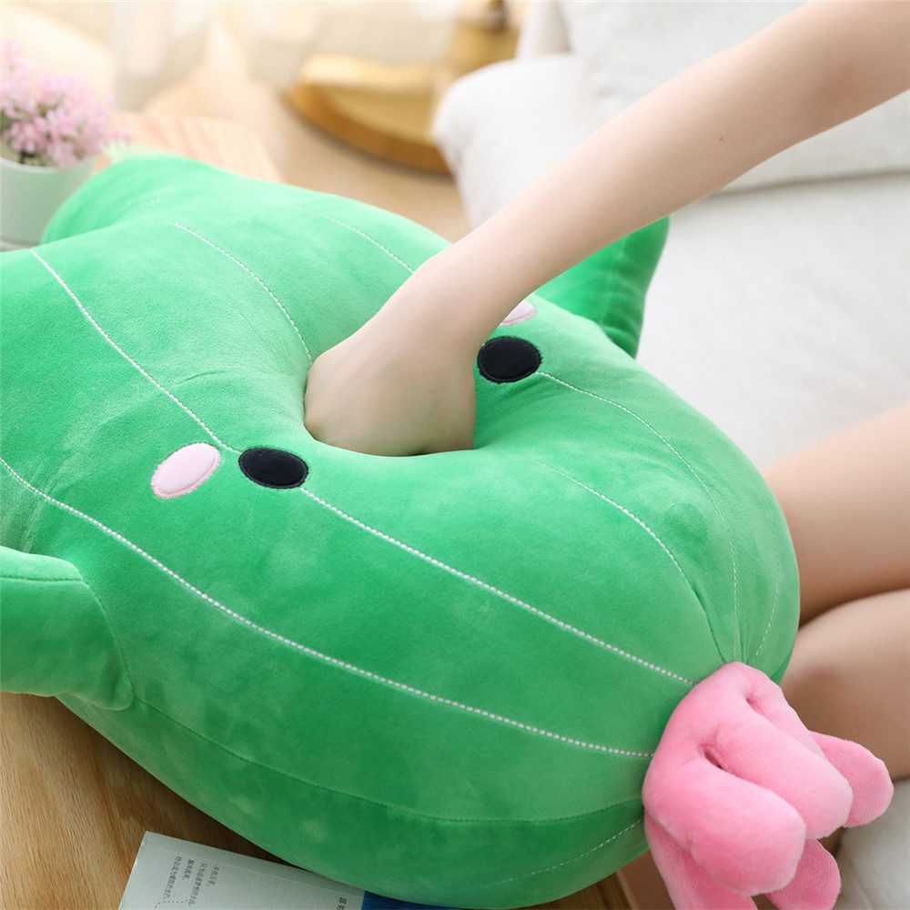 Cactus Plush Toy – Cozy Pocket Bloom Green cactus plush toy with hand inserted into central pocket, pink flower at base, and cartoon face.