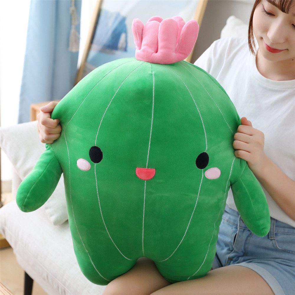 Cactus Plush Toy – Blooming Buddy Edition Large green cactus plush toy with white stripes, pink cheeks, smiling face, and pink flower on top.