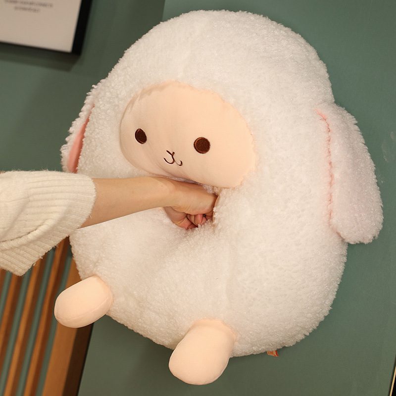 Round Sheep Plushie – Cozy Pocket Pal Round sheep plushie with peach face and hand inserted into its belly, suggesting a warmer feature.