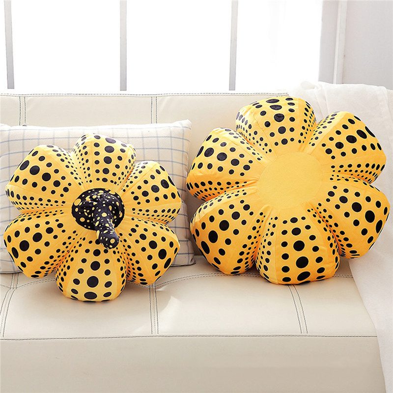 Pumpkin Plushies – Cozy & Artistic Duo Two yellow pumpkin plush cushions with black polka dots placed on a light-colored couch.
