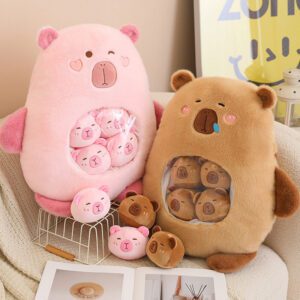 Two capybara plush toys, one pink and one brown, each with transparent belly pockets containing mini plush bears.