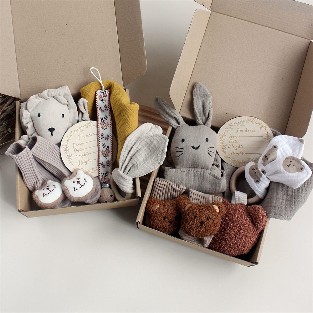 Newborn Gift Box Set – Twin Treasures Edition Two newborn gift boxes with plush toys, socks, headbands, bibs, and engraved plaques.