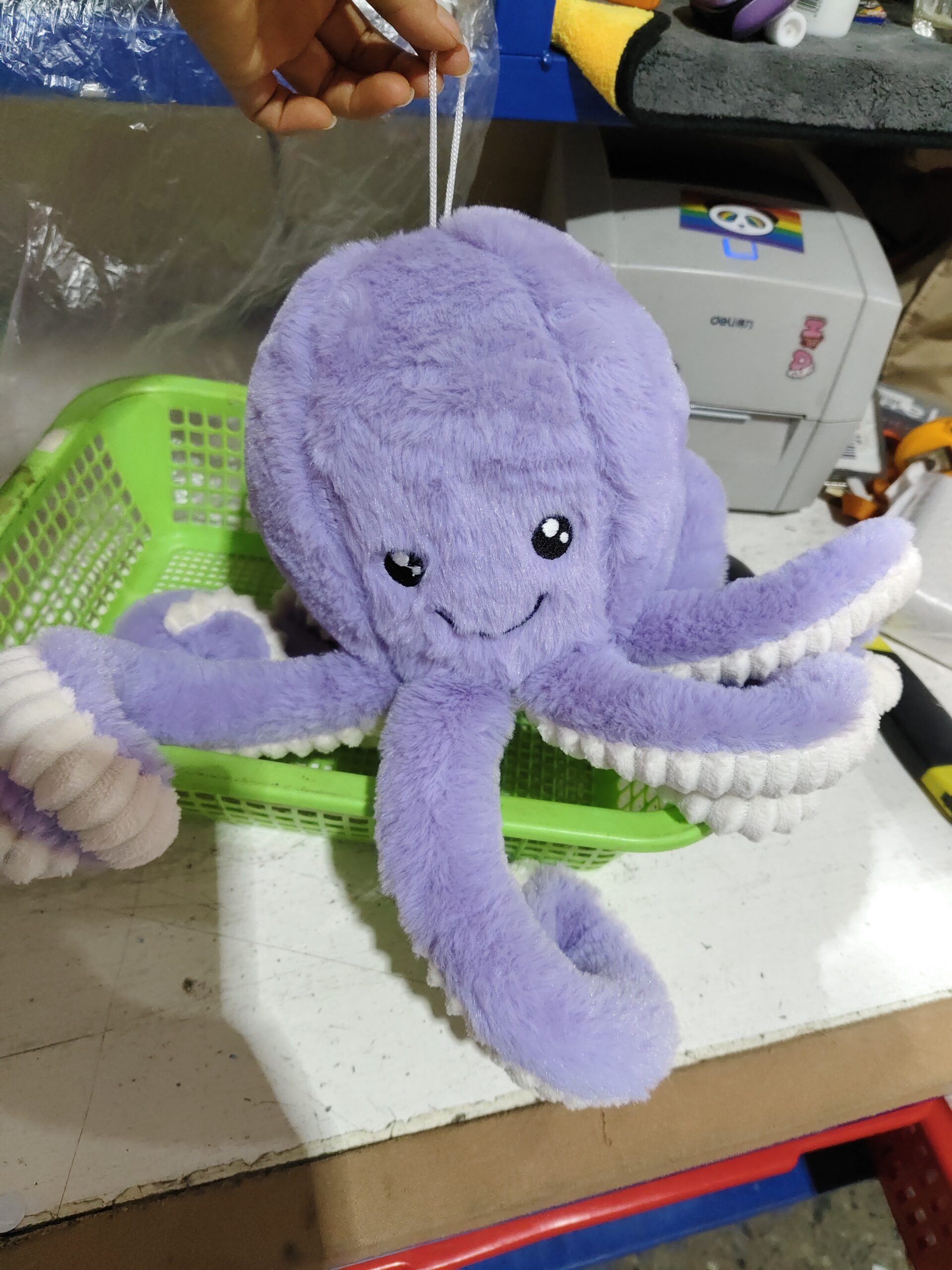 Octopus Stuffed Animal Plushie – Cozy Shelf Sitter Light purple octopus stuffed animal plushie sitting on a green basket in a workspace with shelves and printer.